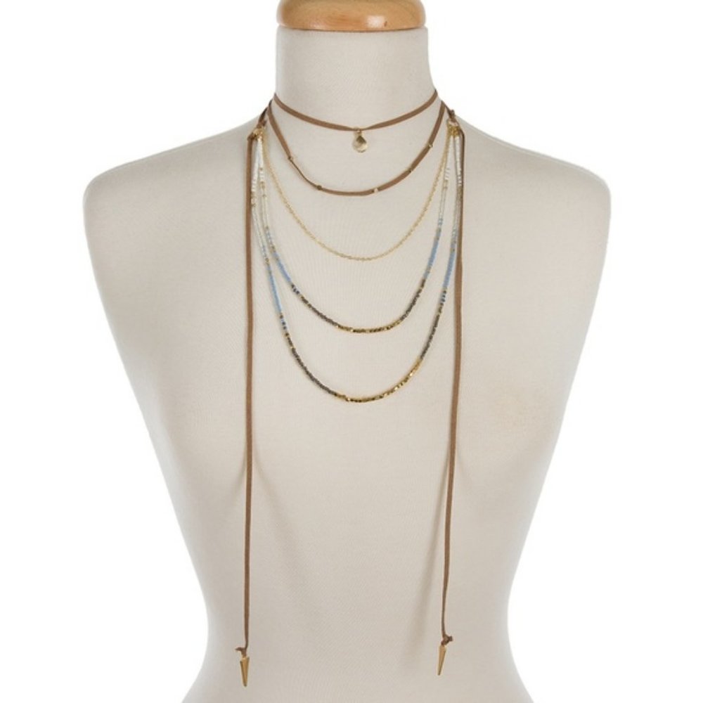 Suede and gold necklace with blue/white beads